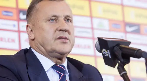 Cezary Kulesza, prezes PZPN, w garniturze i krawacie, z mikrofonem przed sobą. Jego majątek budzi zainteresowanie.