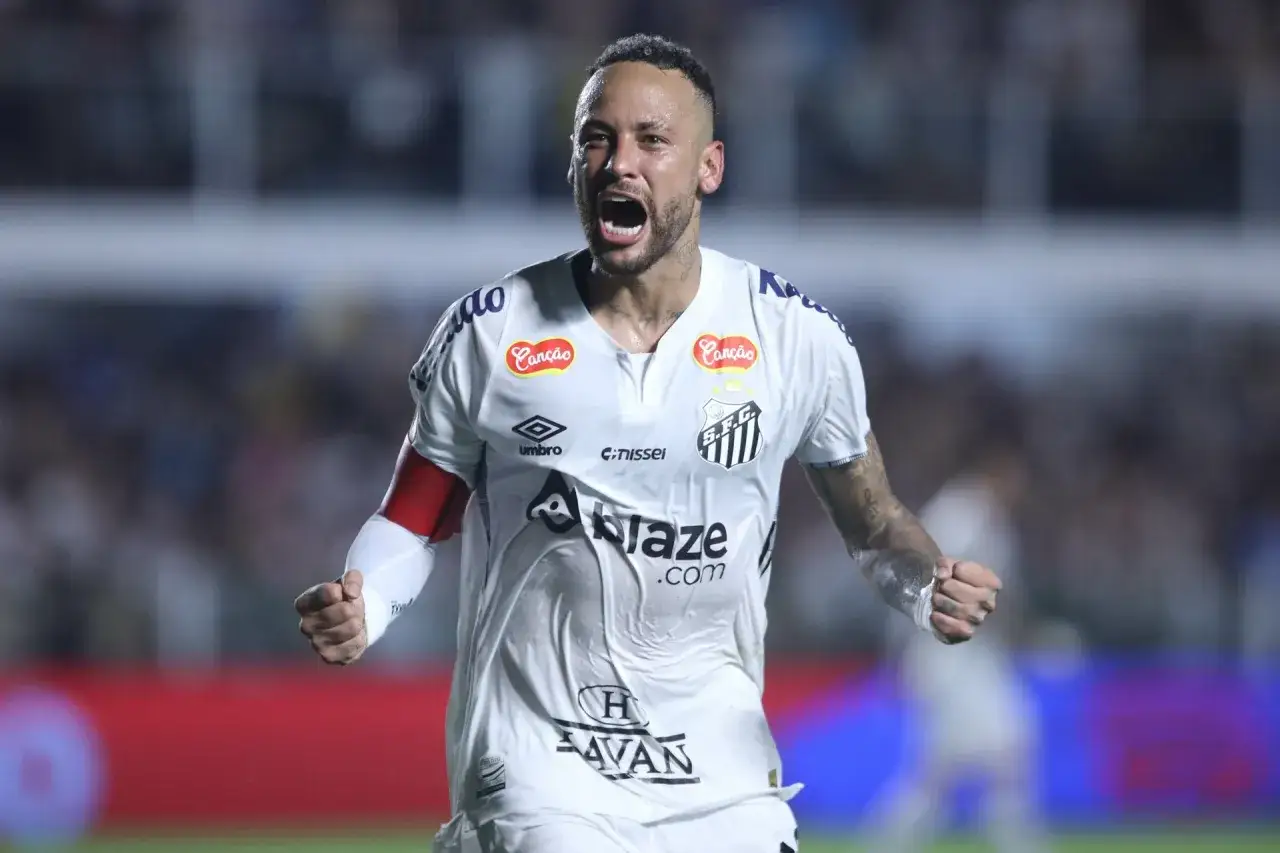 Neymar w białej koszulce Santos, krzyczy z radości. Jego zarobki budzą podziw, a gra na boisku zachwyca.